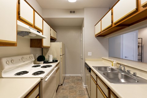 a kitchen with a stove and sink and a refrigerator