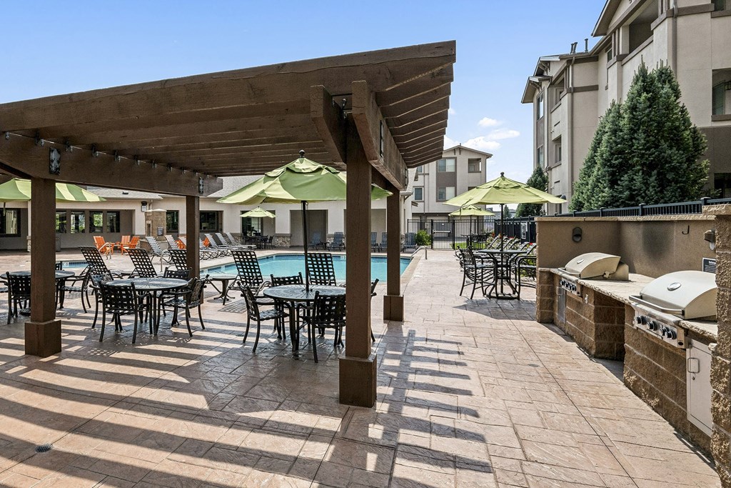 Poolside grilling station with ample seating - First and Main Apartments