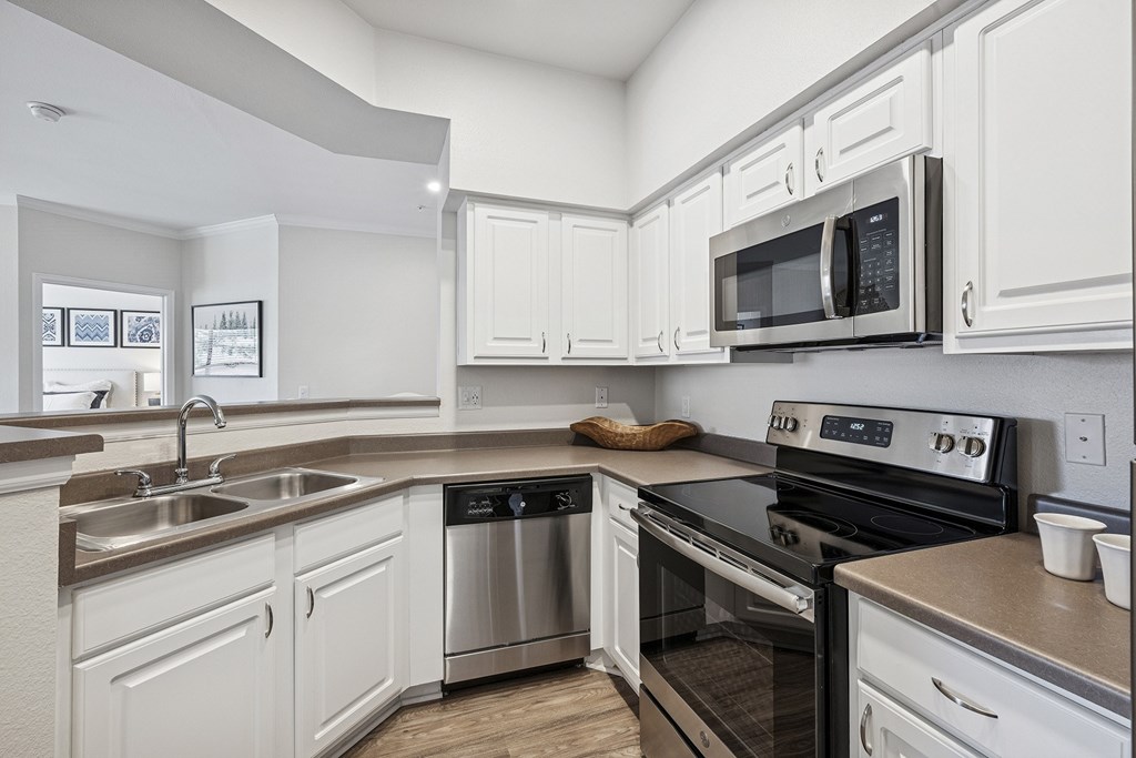 Modern and upgraded kitchens with wood-style flooring - Grand Centennial Apartments