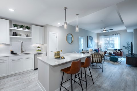 A modern kitchen with white cabinets and a large island.