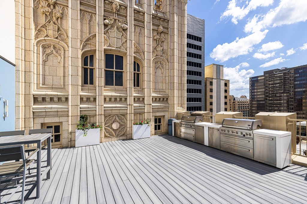Rooftop outdoor kitchen with BBQ grills and seating - The Kirby