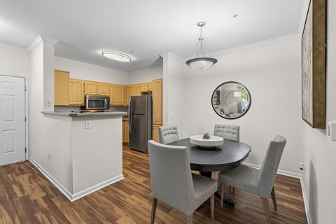 A kitchen with a table and chairs.