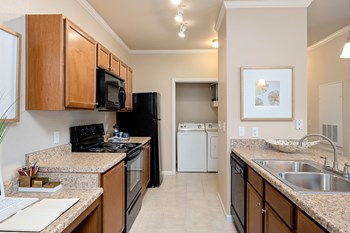 Cordillera Ranch Apartments side-by-side laundry machines - Photo Gallery 18