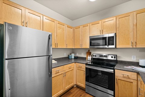 a kitchen with stainless steel appliances and wooden cabinets