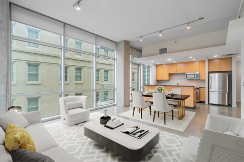 A modern living room with a white couch and a coffee table.