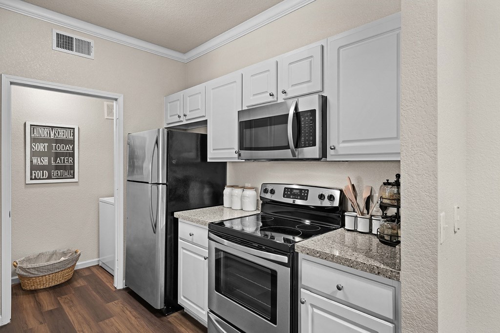 a kitchen with stainless steel appliances and white cabinets