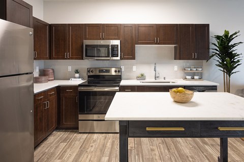 a kitchen with stainless steel appliances and wooden cabinets