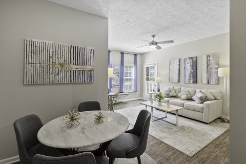 A modern dining room with a round table and chairs.