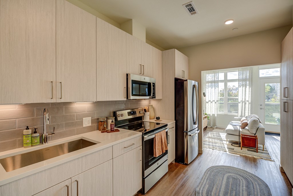 Large white cabinetry in kitchens in select units - BLVD at Revere Beach