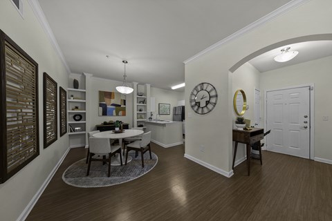 A dining room with a table and chairs.