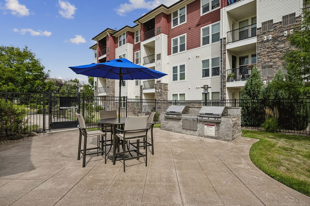BBQ grilling station with picnic tables - Enclave at Cherry Creek
