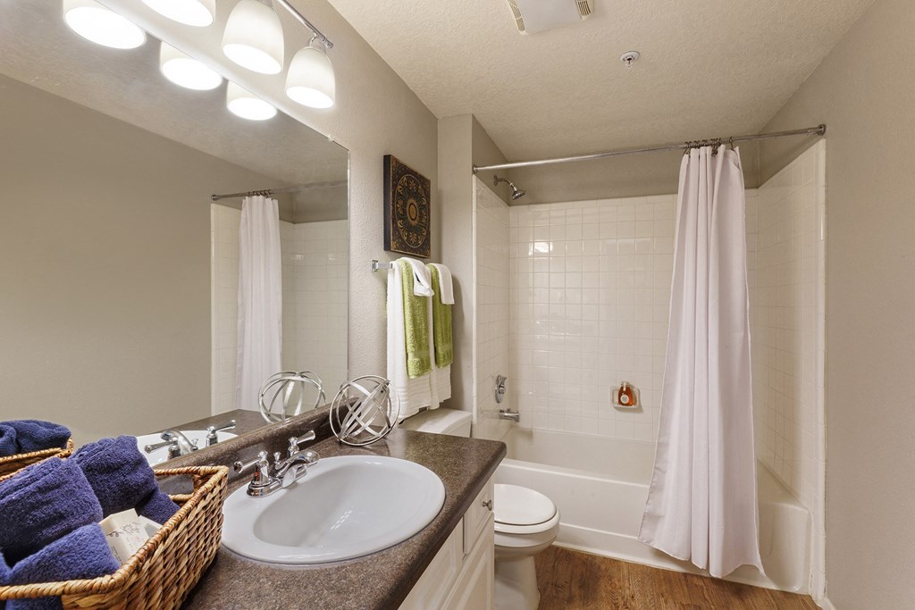 The Vineyards bathroom with wood-style flooring