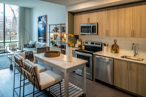 A modern kitchen with a dining table and chairs.