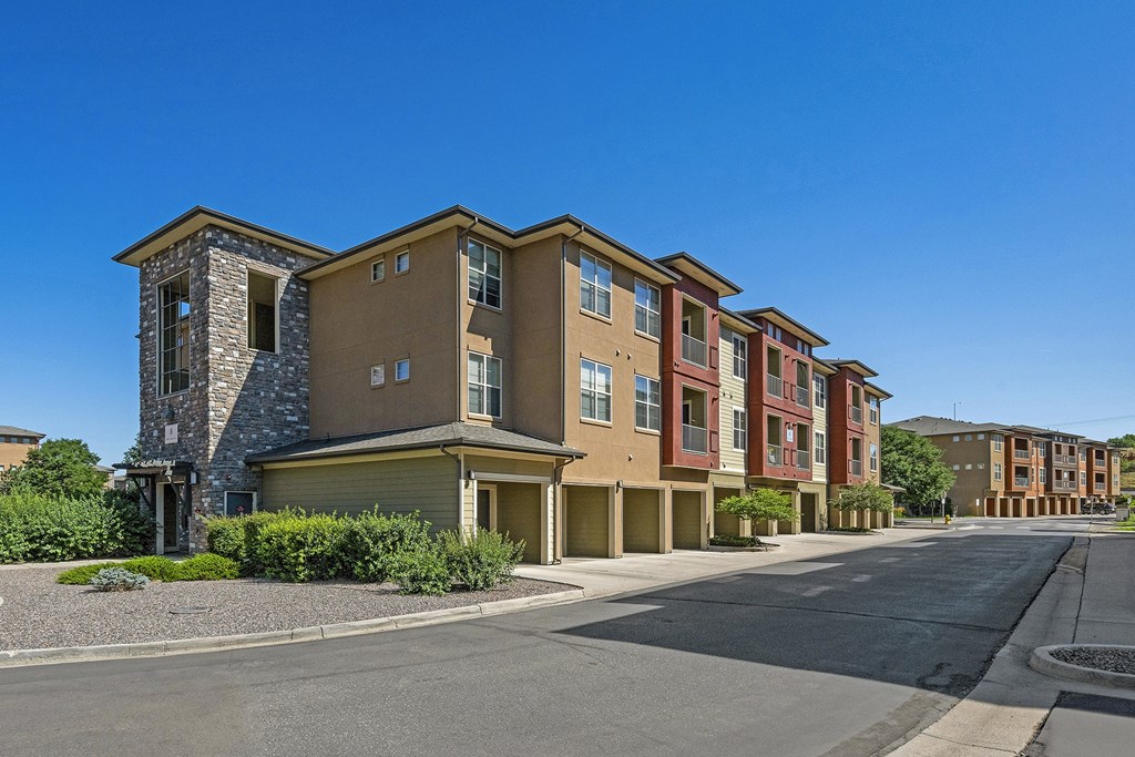 A row of modern apartment buildings with a clear blue sky above.