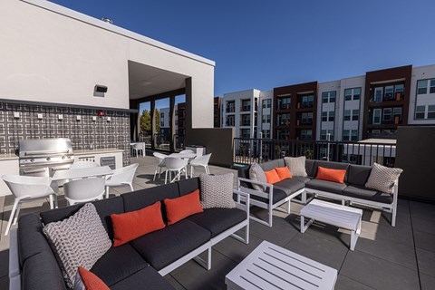 Rooftop deck with a fireplace and outdoor cooking station - NOVA at Green Valley
