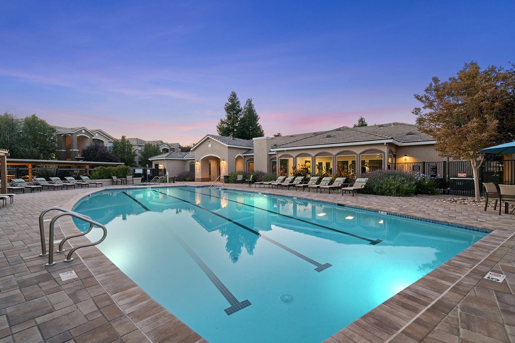 Lighted resort-style swimming pool at dusk