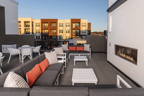 Rooftop deck with a fireplace and outdoor cooking station - NOVA at Green Valley