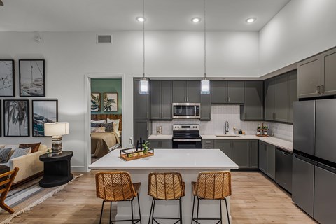 A modern kitchen with a dining table and chairs.