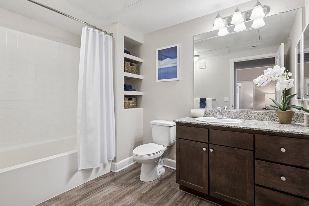 Chestnut cabinetry in baths and kitchens - First and Main Apartments