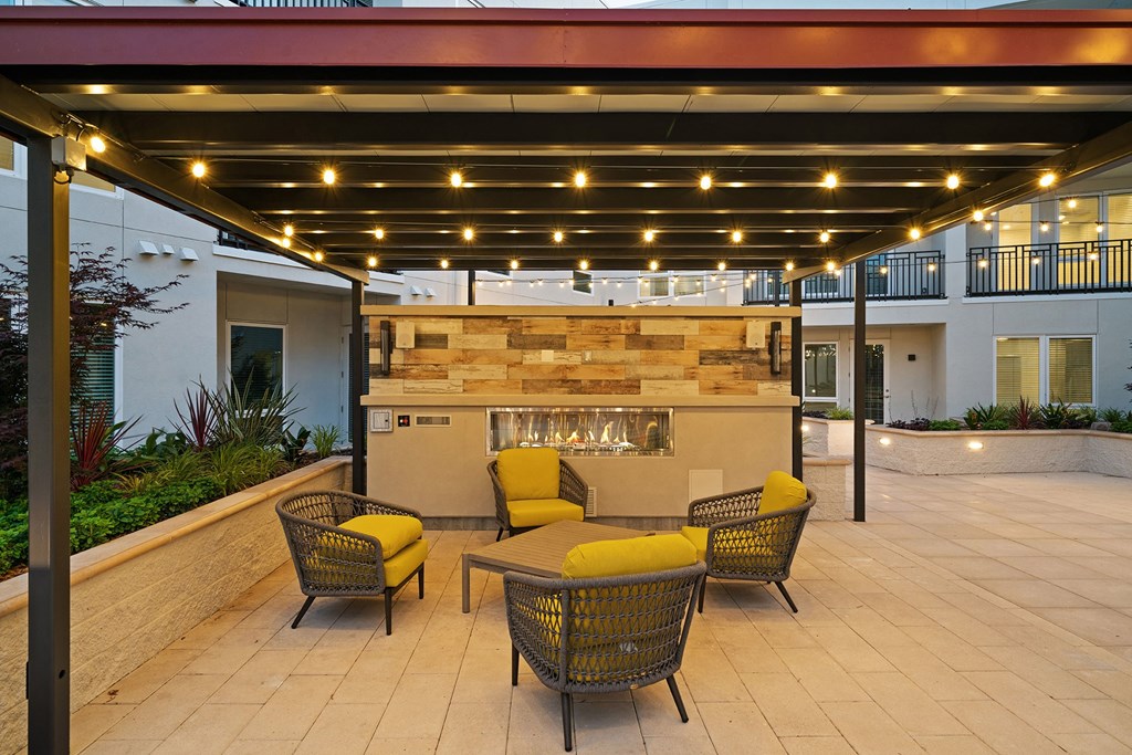 Outdoor fireplace with seating - La Via Apartments