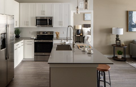 a kitchen with stainless steel appliances and white cabinets