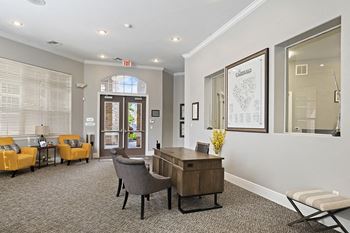 The Fairways at Corbin Park information center with desk and lounge chairs
