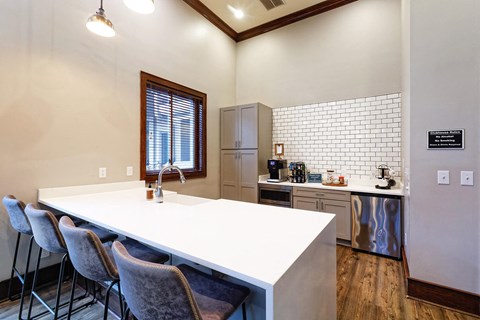 a kitchen with a white counter top and a sink