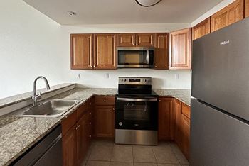 a kitchen with stainless steel appliances and granite counter tops