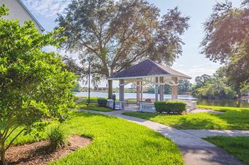 The Colony at Deerwood Apartments - Lakeside gazebo with fire pit and seating area
