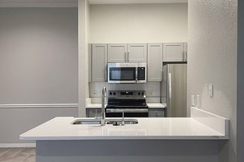 Upgraded kitchen countertops in select units - Versant Place Apartments