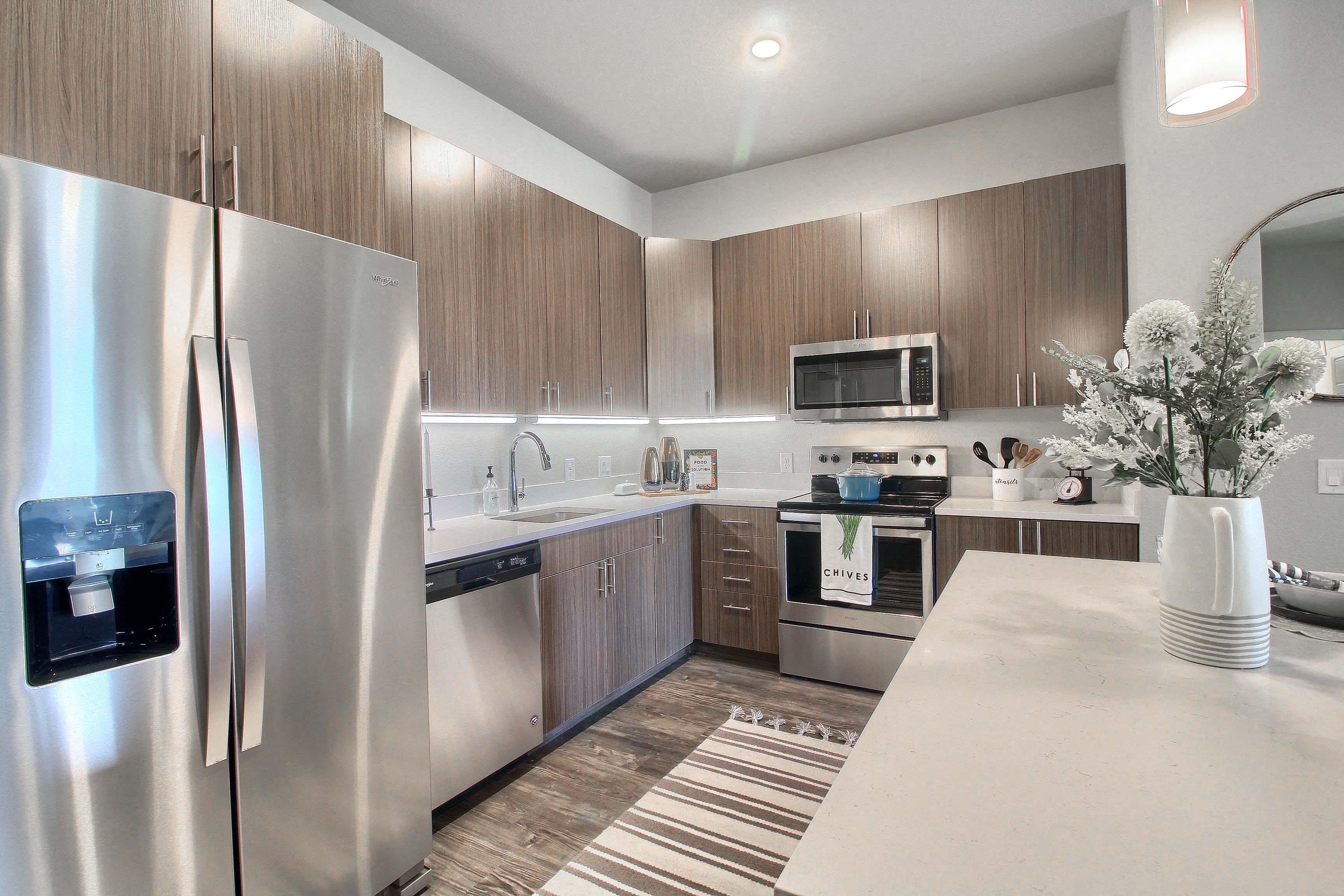a kitchen with stainless steel appliances and wooden cabinets