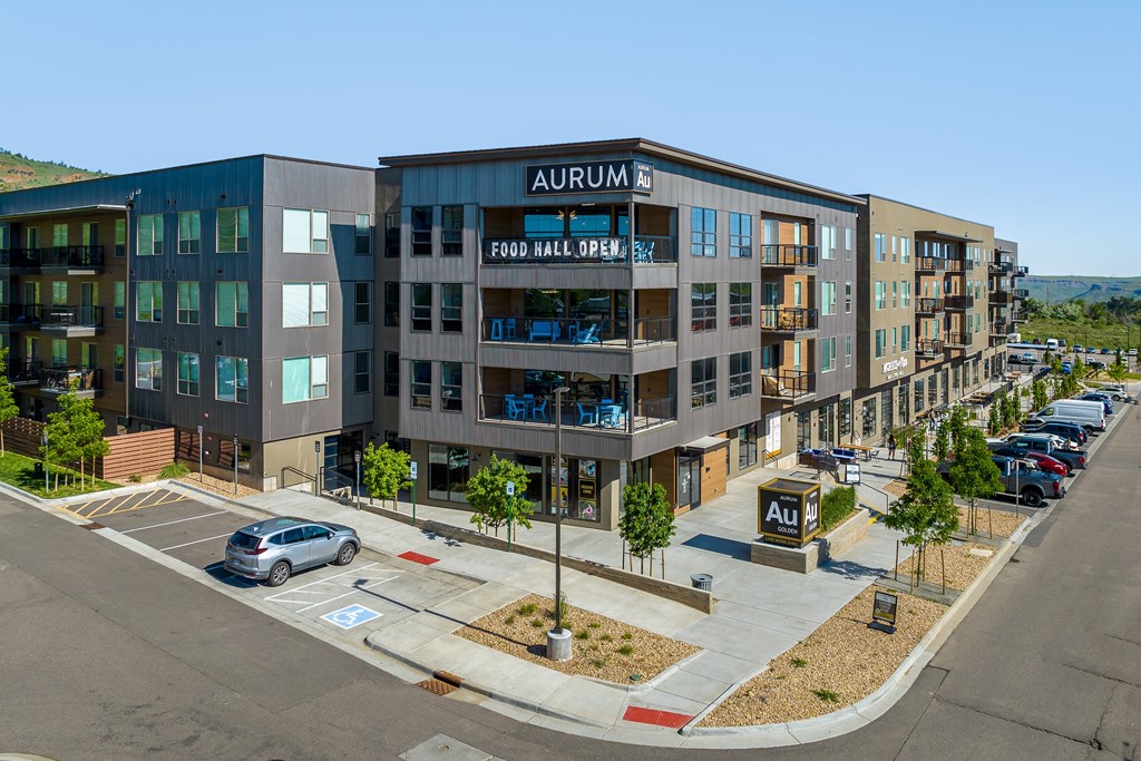an aerial view of a building with a car parked in front of it