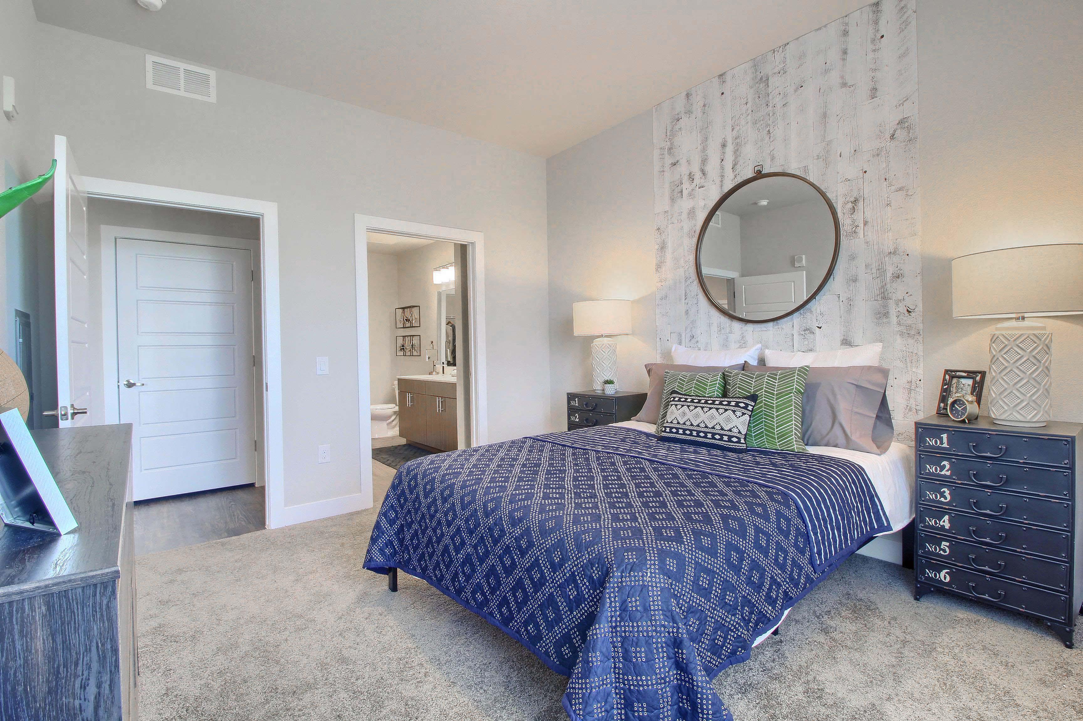 a bedroom with a bed and a mirror