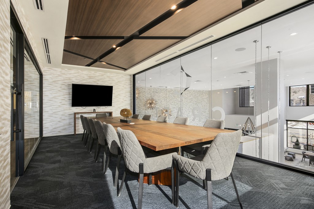 a large dining room with a wooden table and chairs