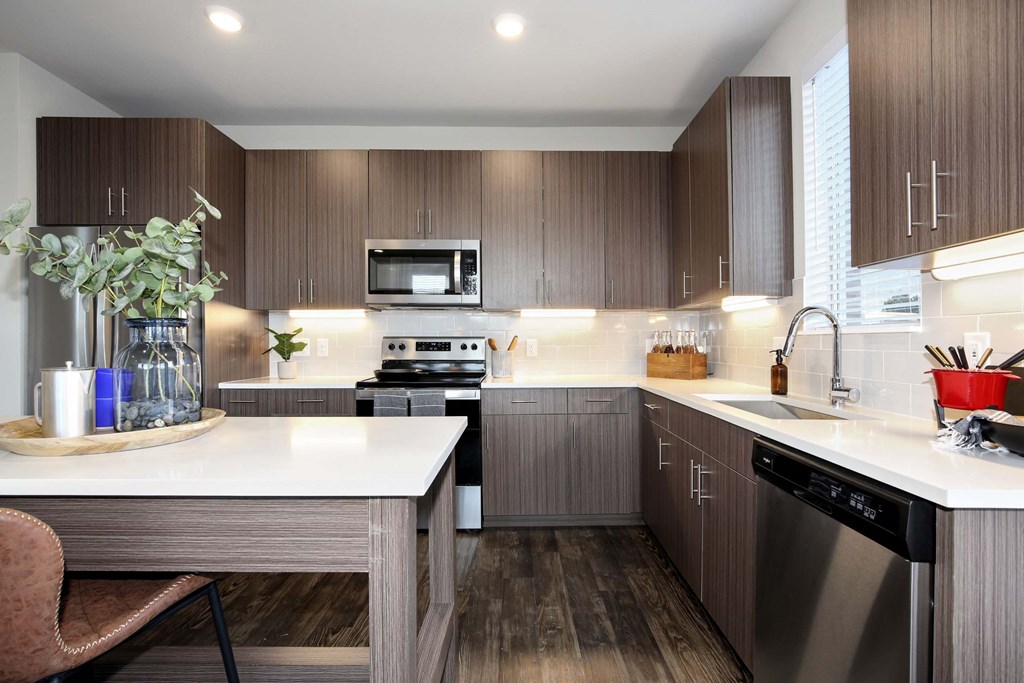 a kitchen with wooden cabinets and a white counter top