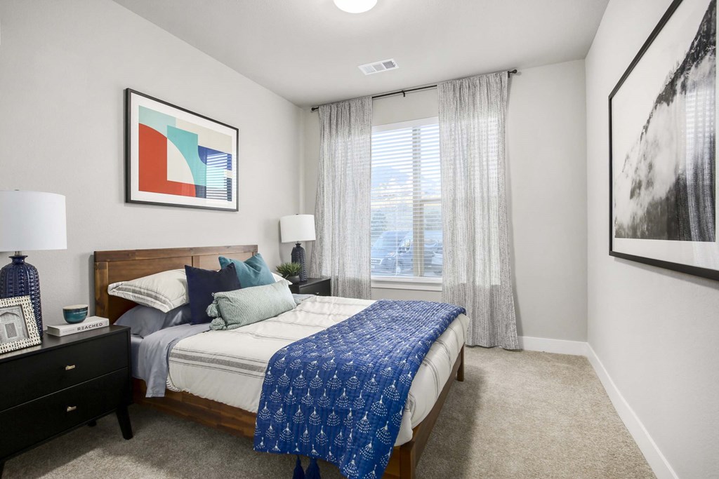 a bedroom with a bed and a large window