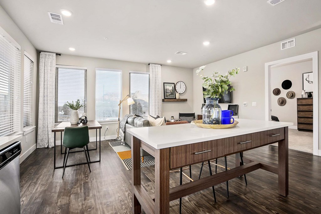 a living room with a kitchen and a dining table