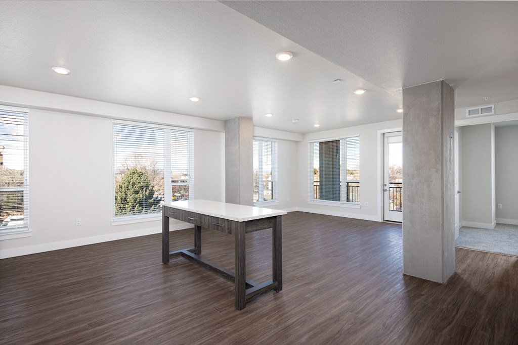 A large, empty room with a long table in the middle.