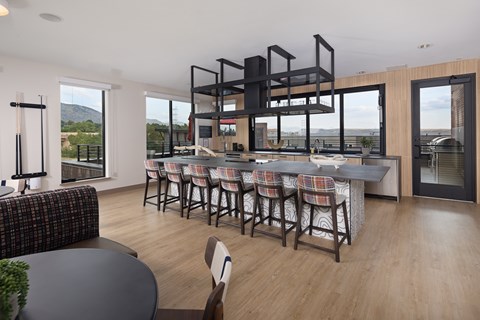 A modern kitchen with a dining table and chairs.