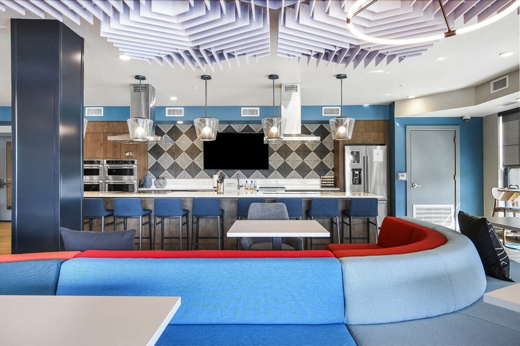 a living room with a couch and a kitchen with a table and chairs