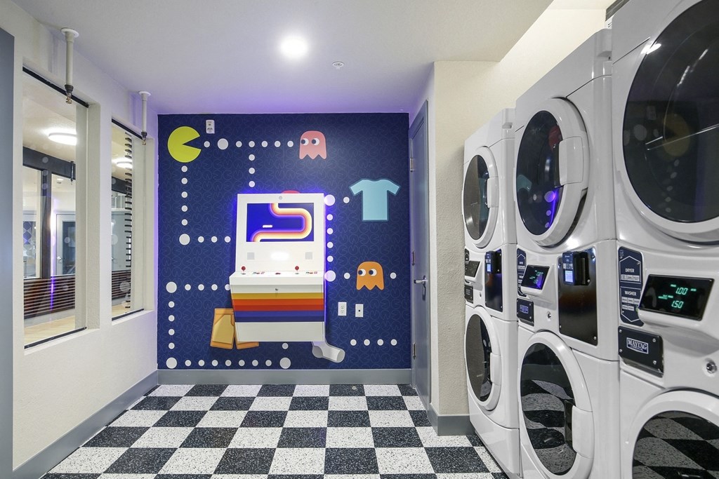 a laundry room with washing machines and a checkered floor