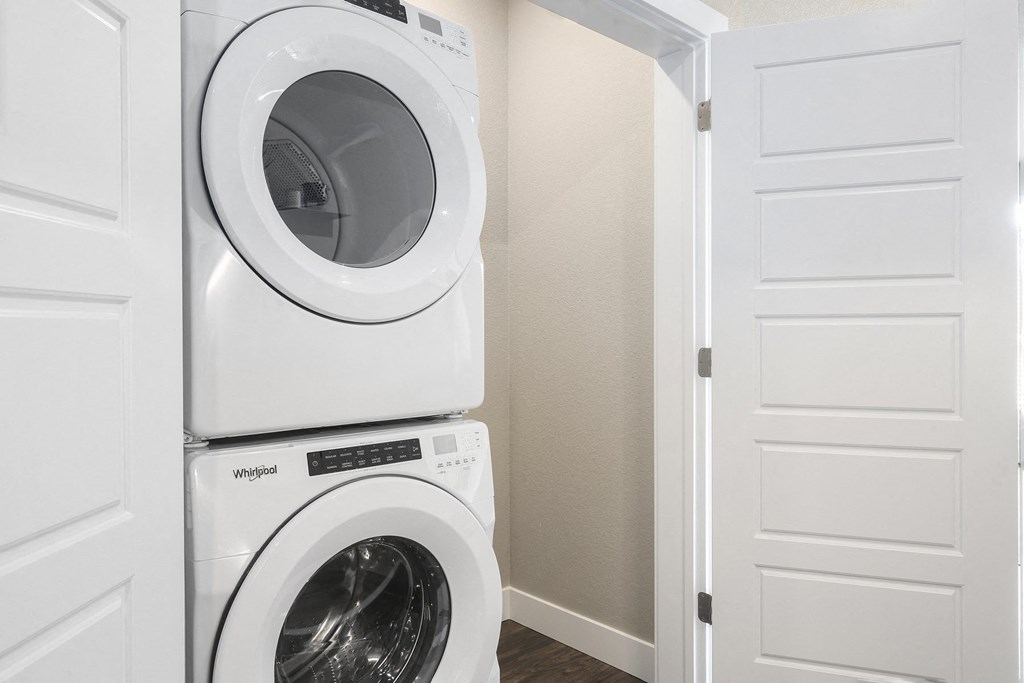 a washer and dryer in a laundry room with a white door
