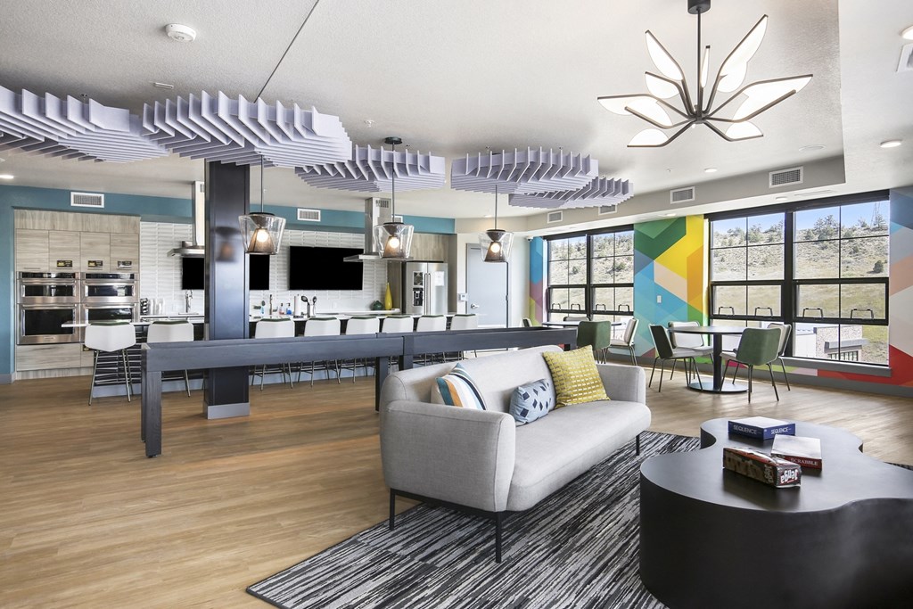 a living room with a couch and a coffee table in front of a dining room