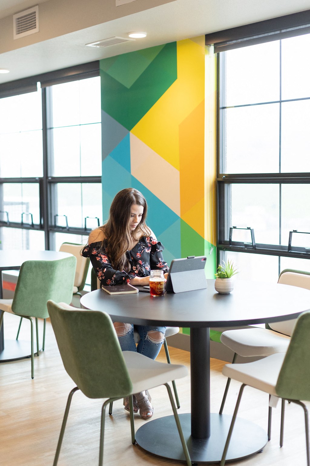 a woman sitting at a table with a laptop