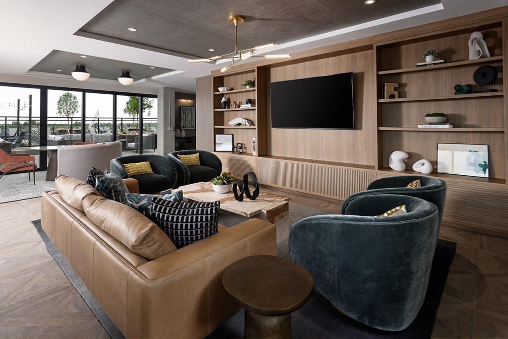 A modern living room with a large couch and a television.