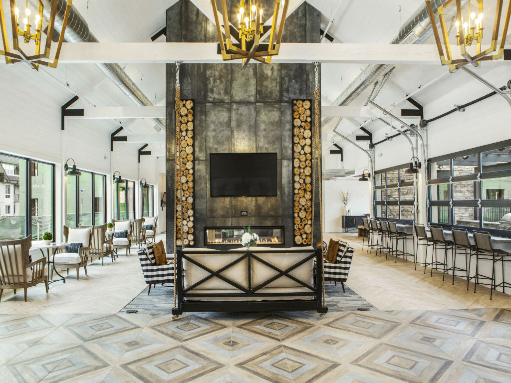 the lobby of a restaurant with a fireplace and tables and chairs