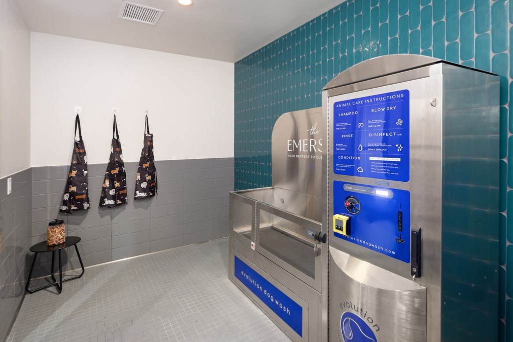 A wall of EMERSON branded dryers in a public laundromat.