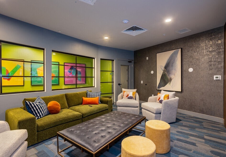 a living room with couches and chairs and a table