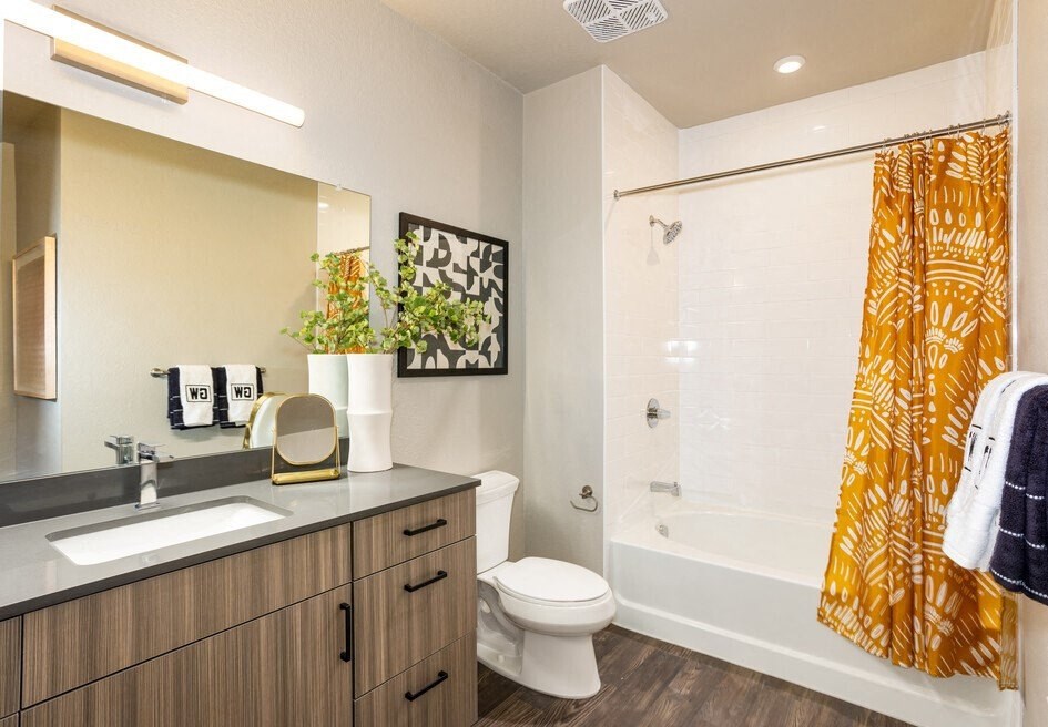 a bathroom with a shower and a sink and a toilet