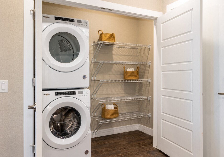 a washer and dryer in a closet with a white door